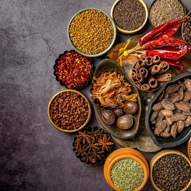 A top view of various Indian spices and seasonings on a table